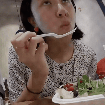 Woman With Bandage Eating Salad With Fork GIF