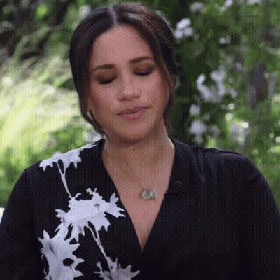 Woman With Black-And-White Dress And Necklace Making Face GIF