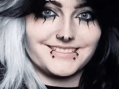Woman With Black And White Hair And Piercings GIF