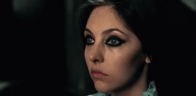 Woman With Black Eyeliner And Blue Shirt GIF