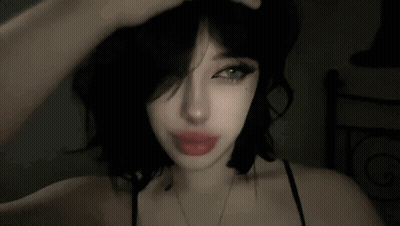 Woman With Black Hair And Red Lips Hand To Head GIF