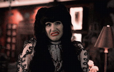 Woman With Black Hair And Red Lips Making A Face GIF