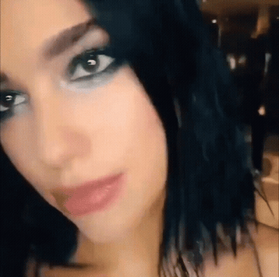 Woman With Black Hair Looking At Camera GIF