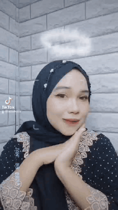 Woman With Black Hijab And Black Dress Making Face GIF