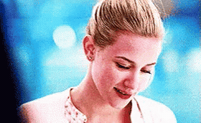 Woman With Blonde Bun Smiling Looking Down GIF