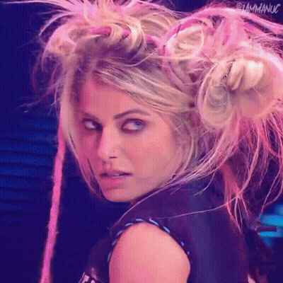 Woman With Blonde Hair And Pink Dreadlocks Looking At Camera GIF