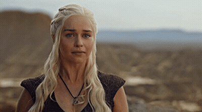 Woman With Blonde Hair In Black Top And Necklace GIF