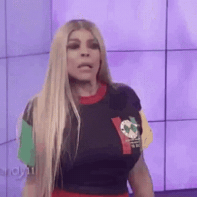 Woman With Blonde Hair In Colorful T-Shirt And Red Skirt GIF