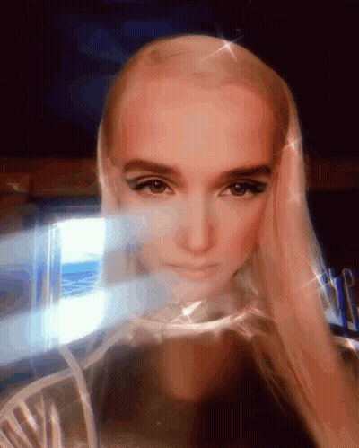 Woman With Blonde Hair Looking At Camera GIF
