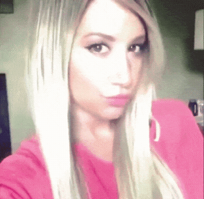 Woman With Blonde Hair Taking Selfie GIF