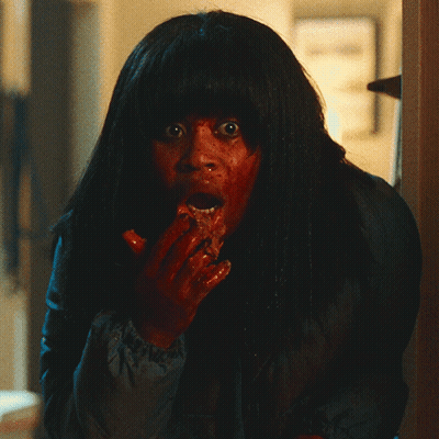 Woman With Blood On Face Holding Something GIF