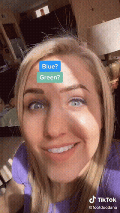 Woman With Blue And Green Sticker On Face GIF