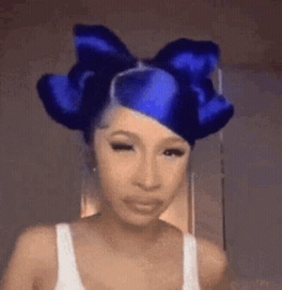 Woman With Blue Bow Making Funny Face GIF