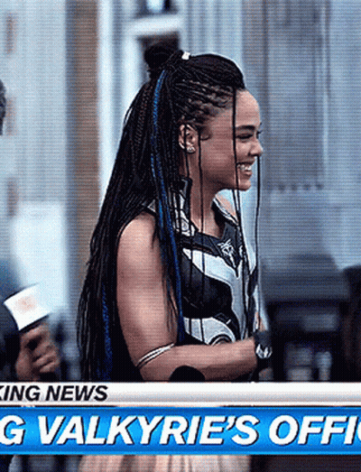 Woman With Blue Braids Standing In Front Of Television GIF
