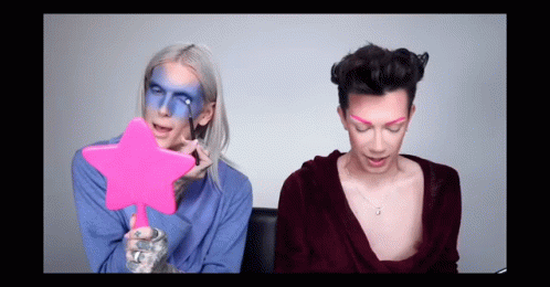 Woman With Blue Face Paint Holding Pink Star Mirror GIF