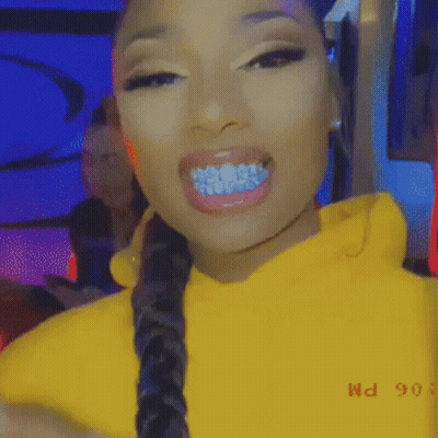Woman With Blue Grills On Teeth In Yellow Hoodie And Braided Hair GIF