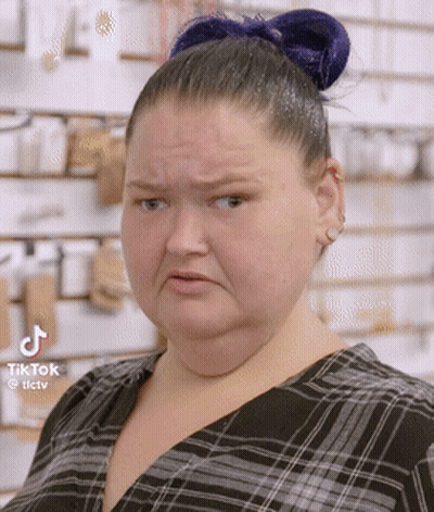 Woman With Blue Hair Bun Making Funny Face GIF