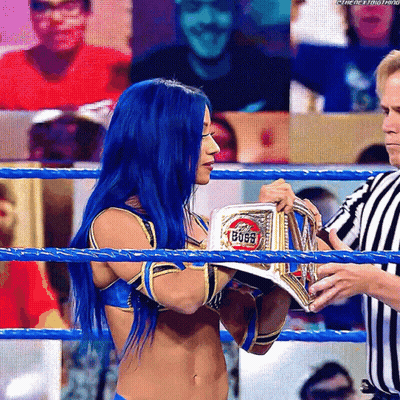 Woman With Blue Hair Holding Boss Belt In Wrestling Ring GIF