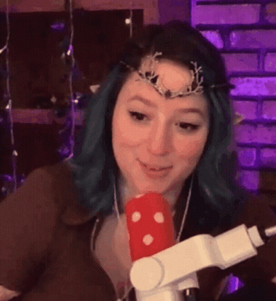 Woman With Blue Hair Holding Microphone And Crown GIF