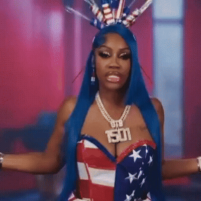 Woman With Blue Hair In American Flag Costume And 501 Necklace GIF