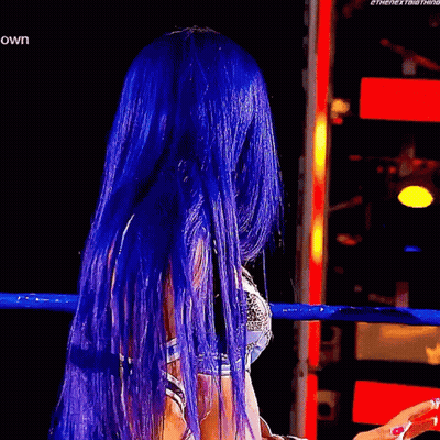 Woman With Blue Hair In Wrestling Ring Hands Up GIF