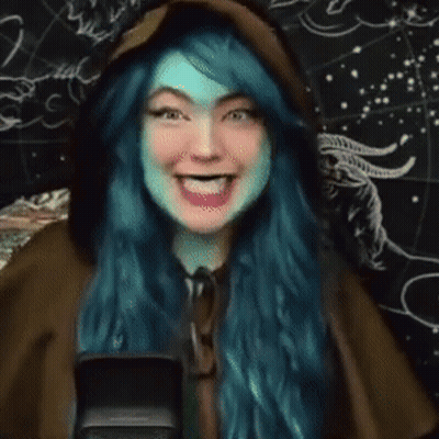 Woman With Blue Hair Laughing At Microphone GIF