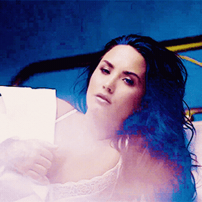 Woman With Blue Hair Laying on Bed