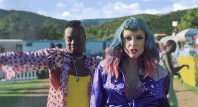 Woman With Blue Hair Next To Man In Yellow Tank Top GIF