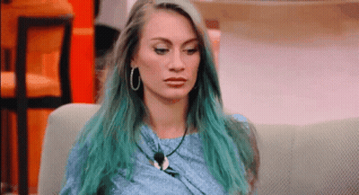 Woman With Blue Hair On Couch Looking At Camera GIF