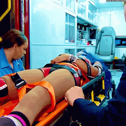 Woman With Blue Hair On Stretcher With Ferno On Leg GIF