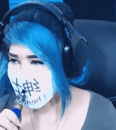 Woman With Blue Hair Wearing Headphones And Mask With Chinese Writing GIF