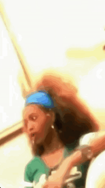 Woman With Blue Headband And Green Shirt GIF
