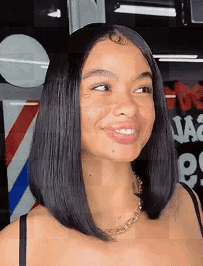 Woman With Bob Hairstyle Smiling At Barber Pole GIF