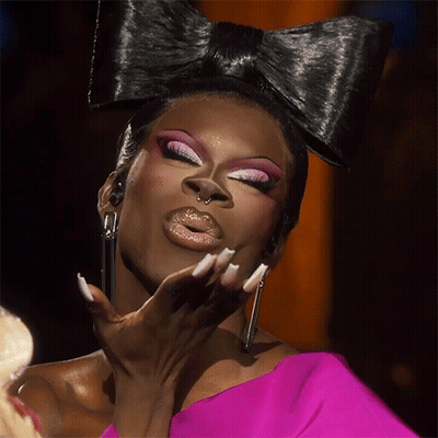 Woman With Bow In Hair And Pink Top GIF