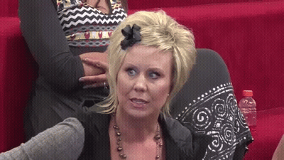 Woman With Bow Sitting On Couch GIF