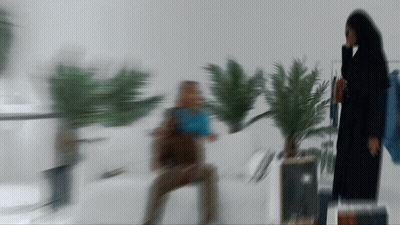 Woman With Bow Sitting On Couch GIF