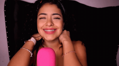 Woman With Braces Smiling Holding Hair GIF