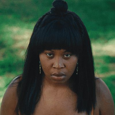 Woman With Braided Hair And Earrings Serious Look GIF