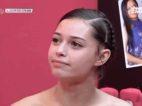 Woman With Braided Hair Looking At Camera GIF