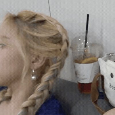 Woman With Braided Hair Next To Coffee GIF