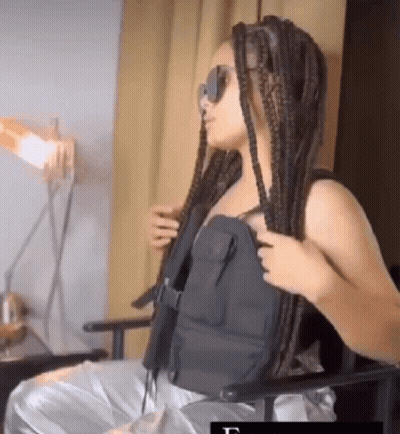 Woman With Braids In Black Vest And Sunglasses GIF