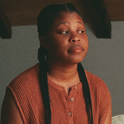 Woman With Braids Making Funny Face Saying Fine GIF