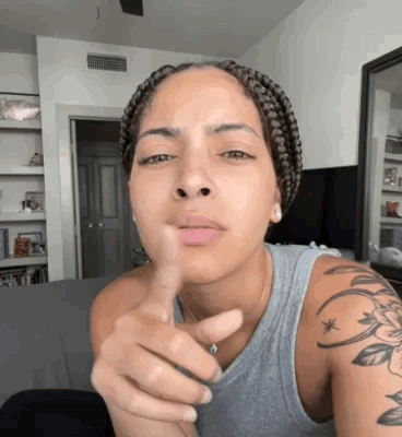 Woman With Braids Pointing At Camera GIF