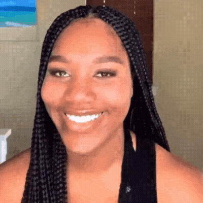 Woman With Braids Smiling In Black Shirt GIF