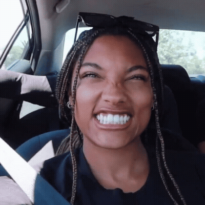 Woman With Braids Smiling In Car Back Seat GIF