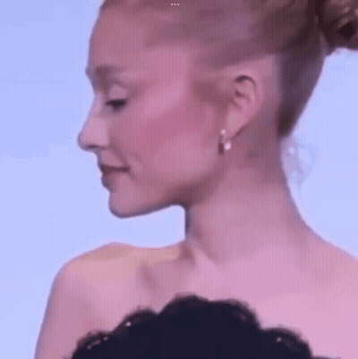 Woman With Bun And Earrings Close Up GIF
