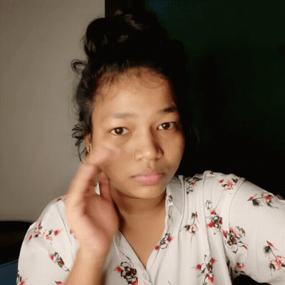 Woman With Bun In White Floral Shirt GIF