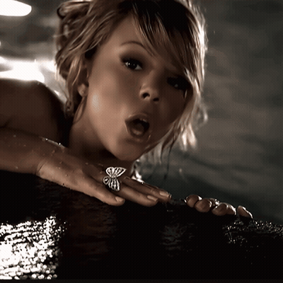Woman With Butterfly Ring Looking At Camera GIF