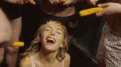 Woman With Carrots On Face Laughs GIF