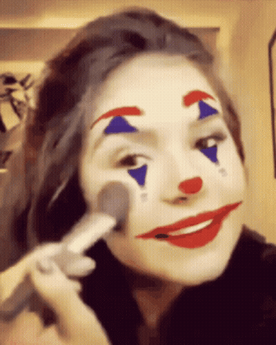 Woman With Clown Face Paint Applying Makeup GIF